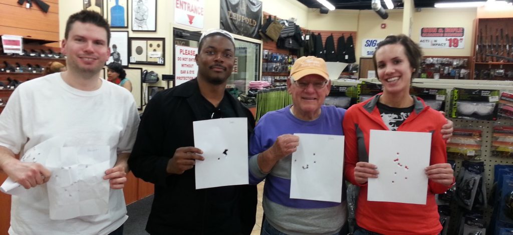 Students holding their targets at the end of a Michigan concealed pistol license class